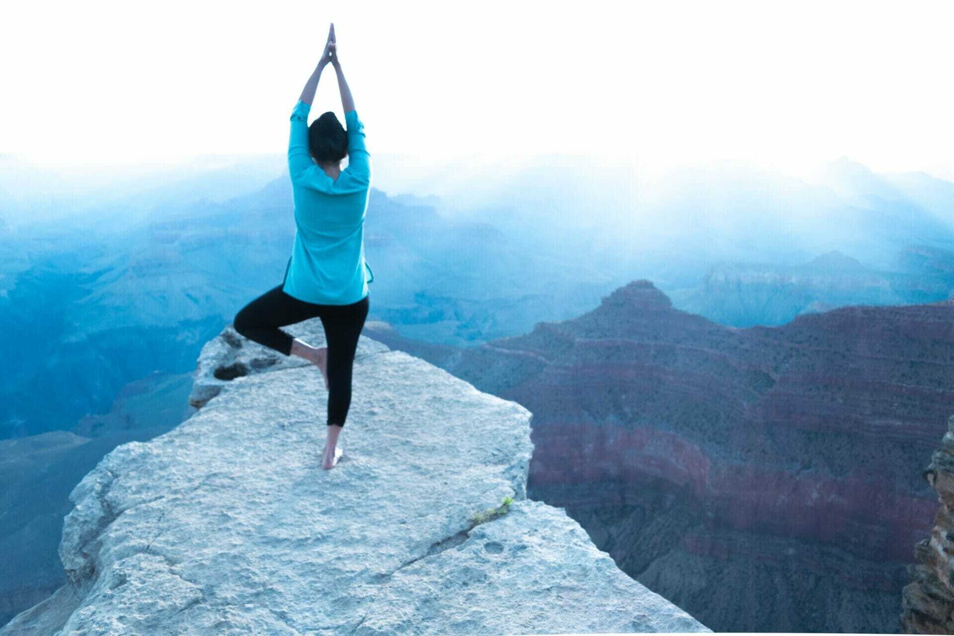 focused girl exercising yoga in grand canyon