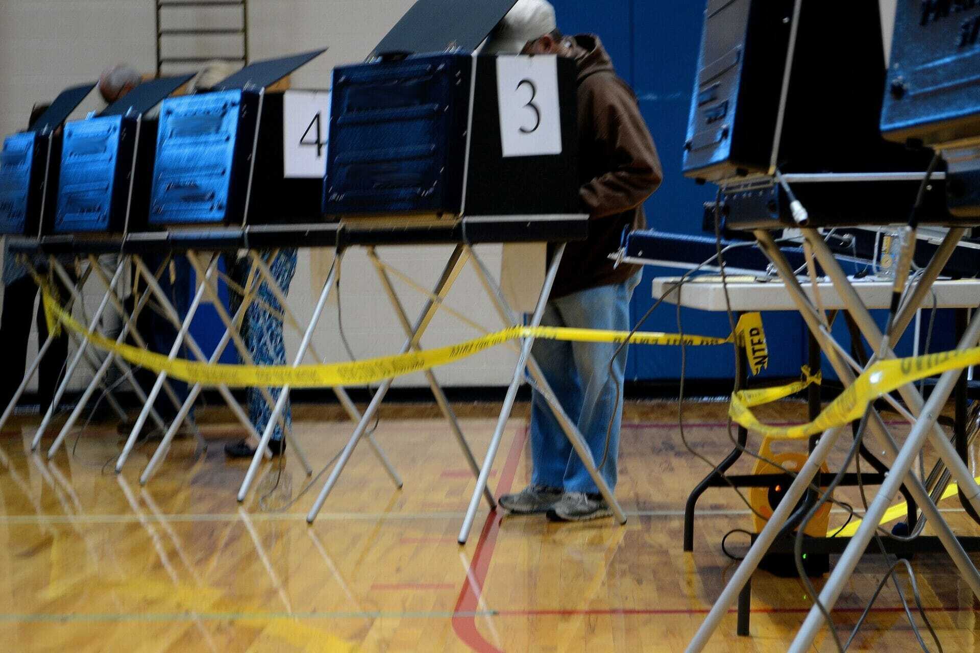 people using voting booths to vote in an election